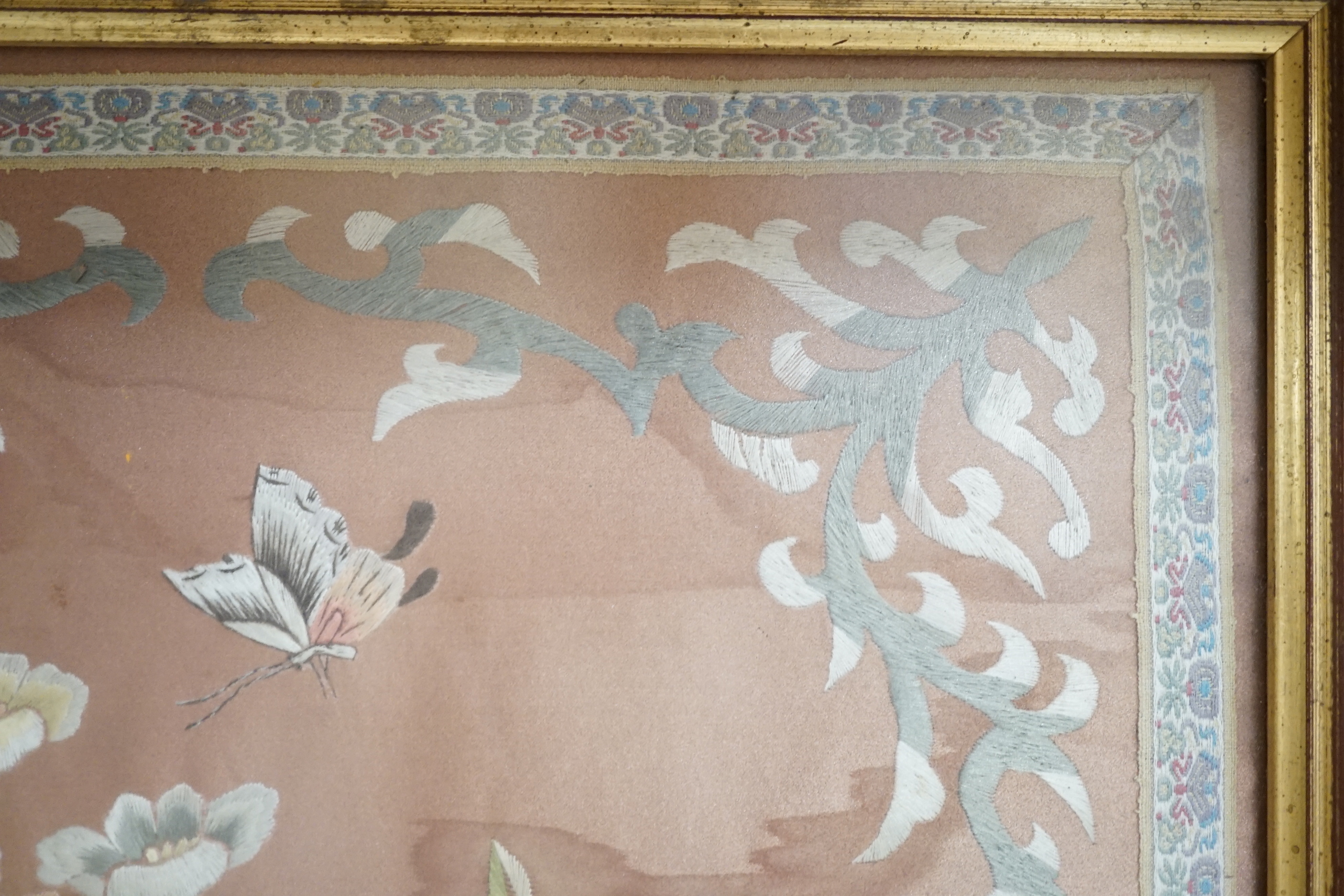 A Chinese silk panel embroidered with flowers and butterflies, framed, 43cm x 38cm